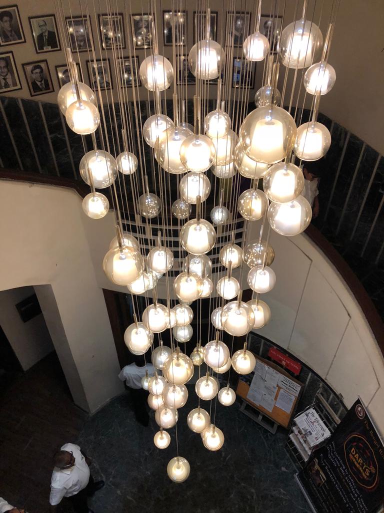 Close view of the suspended globe chandelier in the DPS Siliguri project