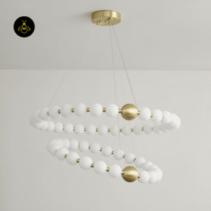 Detail of the brushed brass finish on the acrylic pearl chandelier rings