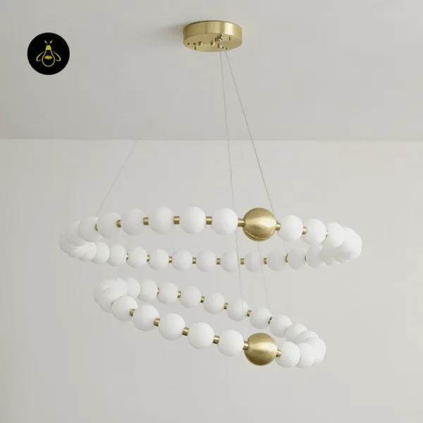 Detail of the brushed brass finish on the pearl chandelier rings