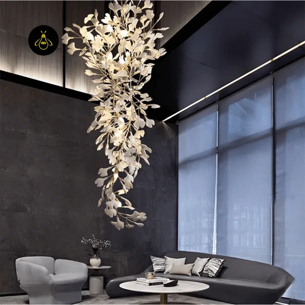 Brass branch detail of the ceramic leaf chandelier showing the gold finish