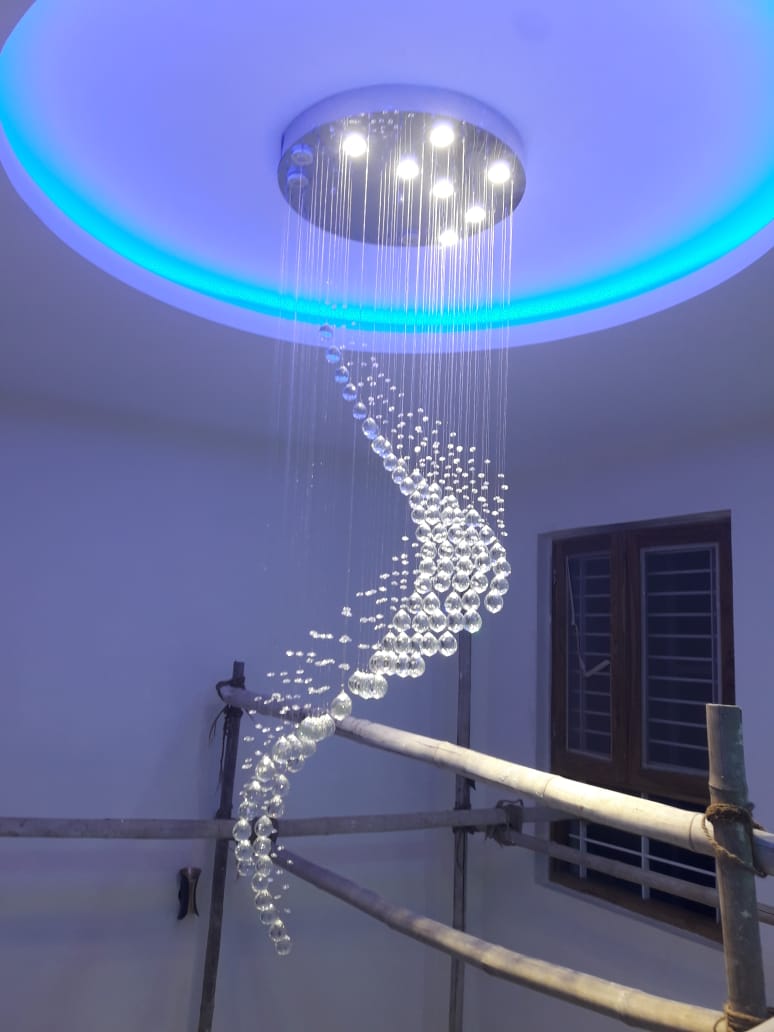 Double-height residential chandelier with flowing crystal drop arrangement in Ranchi