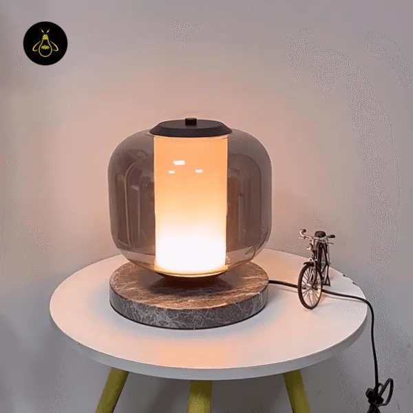 Black marble table lamp lighting a modern bedroom side table