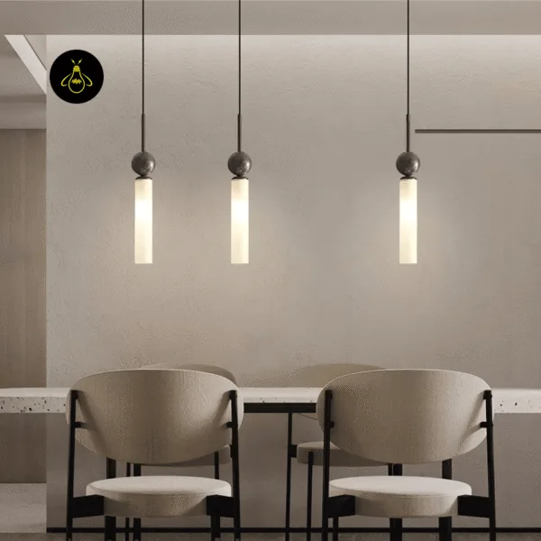 Row of three marble pendant light drops with dark stems over a dining table