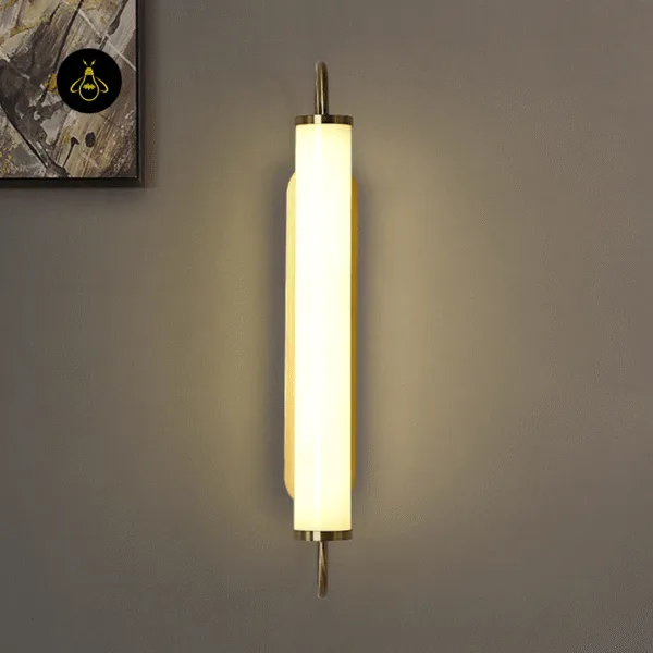 Thin wall light switched on, its warm 3000K glow washing a taupe wall next to an abstract painting