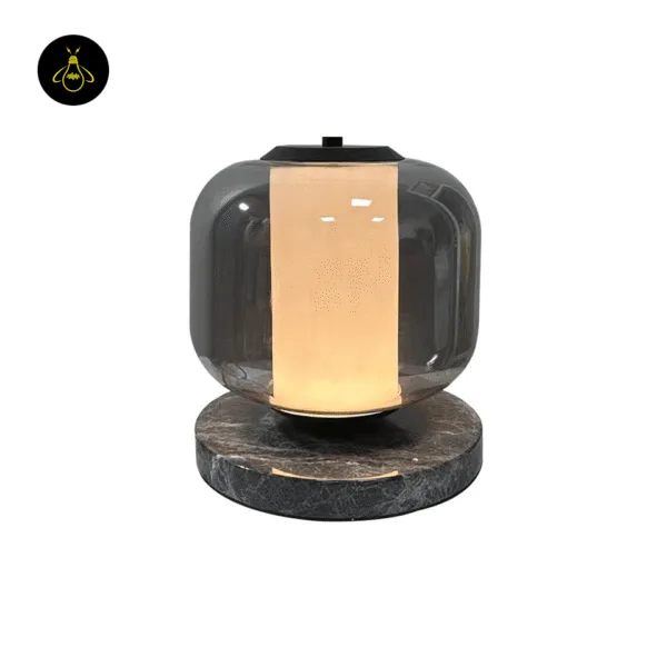 Black marble and smoked borosilicate glass table lamp with glowing opal cylinder core