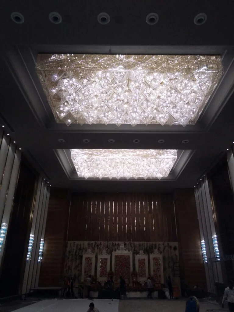 Two recessed crystal ceiling installations visible inside the banquet hall at Zestin Luminary Sahibabad