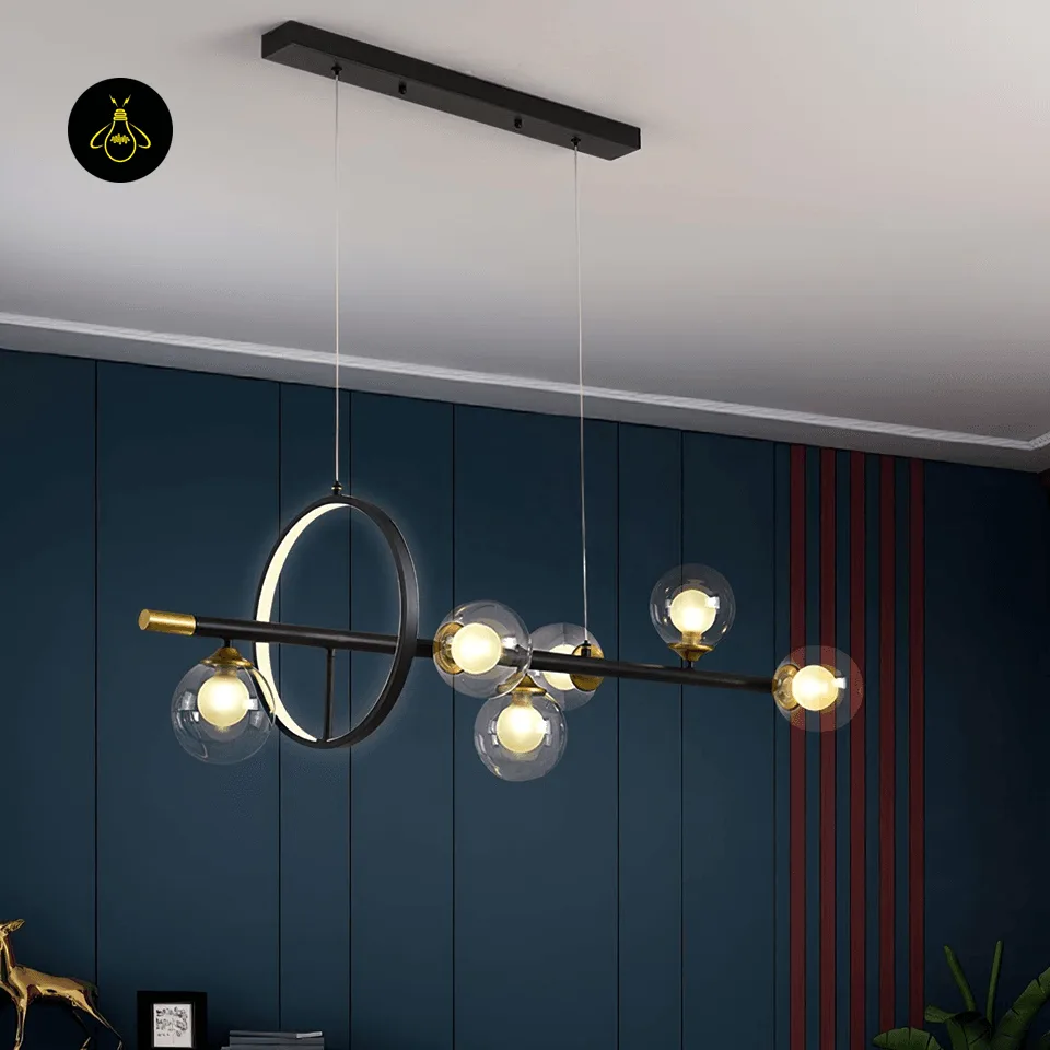 Dining Table Chandelier – 6-Globe Linear Glass & Brass Light with LED Ring, 120 cm 5 Glass globe linear dining table chandelier over a restaurant table in a blue panelled room