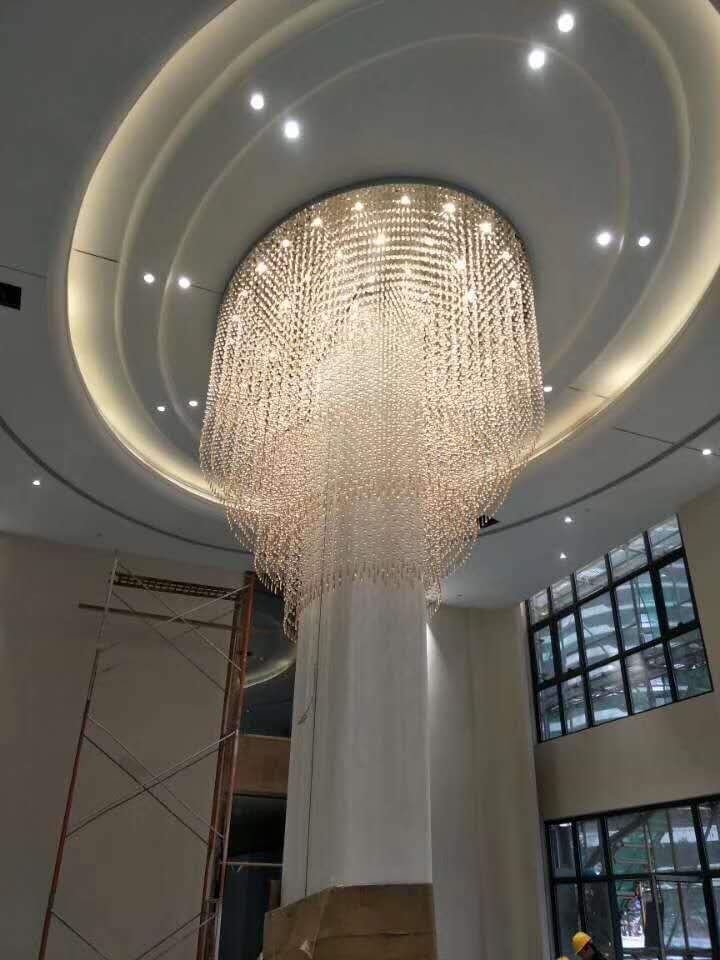 Fluid ribbon-style crystal chandelier suspended inside the banquet hall at Grand Howrah Banquets Kolkata