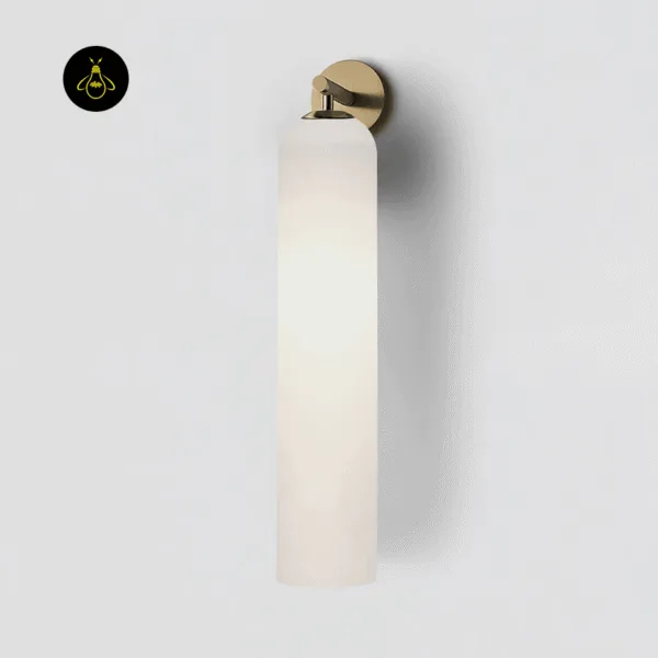 Close-up of the opal borosilicate glass cylinder and lacquered gold arm of the glass wall light