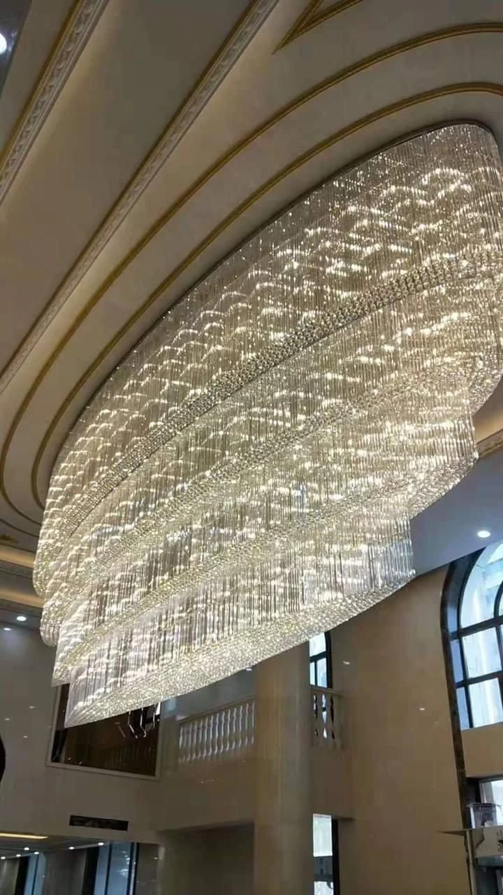 Hotel lobby chandelier Jaipur, the Rajmahal Luminescence layered crystal cascade glowing under a gold-trimmed ceiling bay