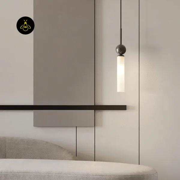 Single marble pendant light with a dark stem glowing beside a living room wall panel