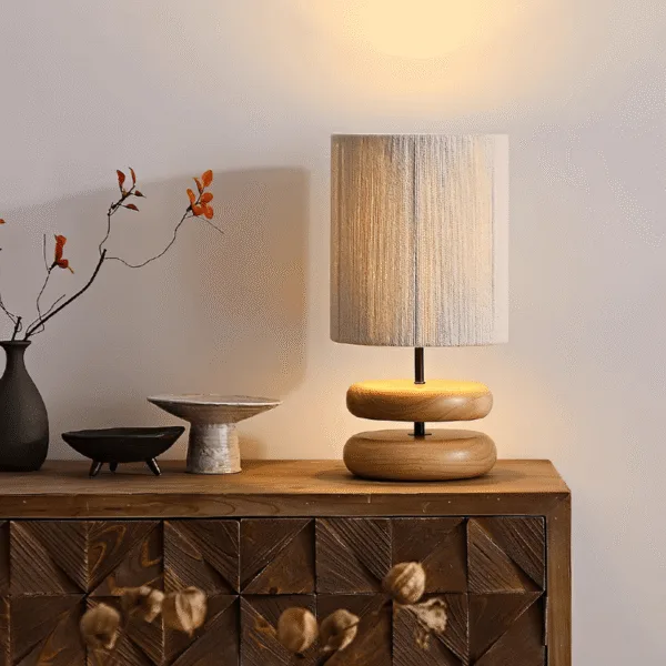 Handcrafted stacked wood-pebble base of the wabi sabi table lamp