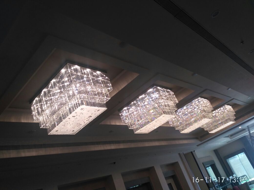 Formal banquet hall view with repeated crystal ceiling chandeliers in Dehradun