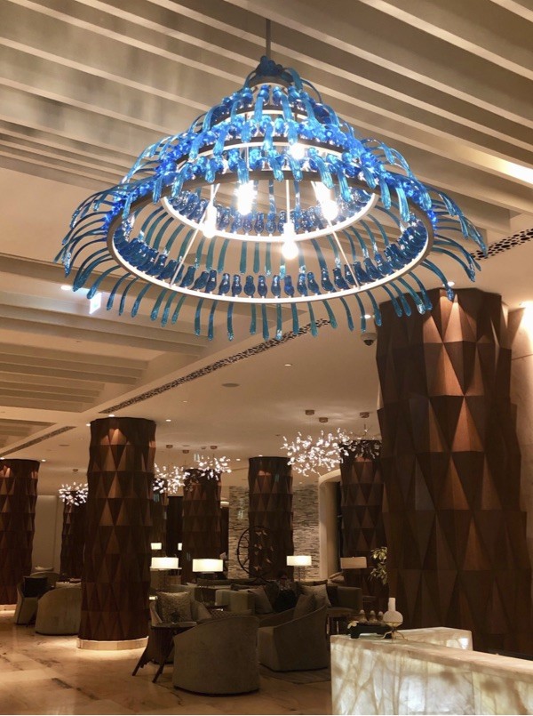 Installed blue bird chandelier above the Hyatt Regency lounge and lobby seating