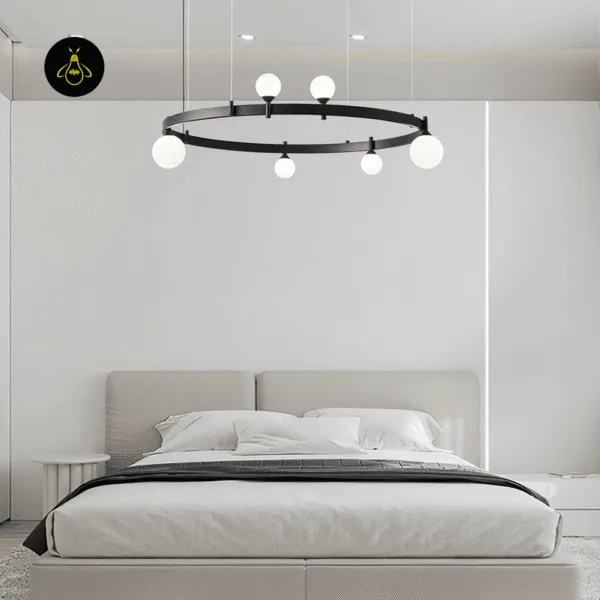 Illuminated modern glass chandelier with soft glowing opal globes above a bedroom