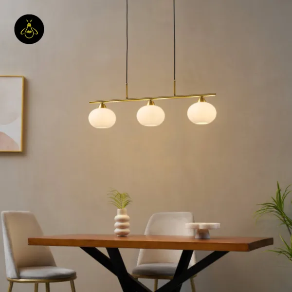 Linear pendant light glowing warm over a wooden dining table in a beige room