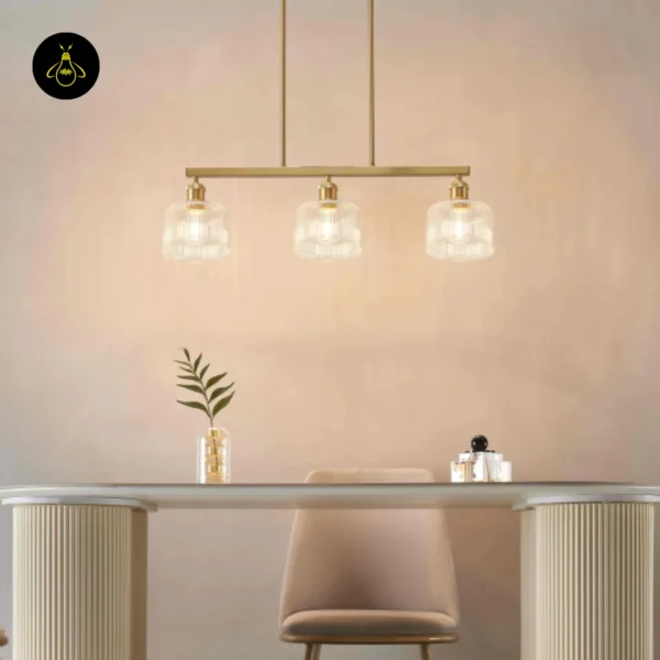 Ribbed glass chandelier lit above a dining table, a beige chair below