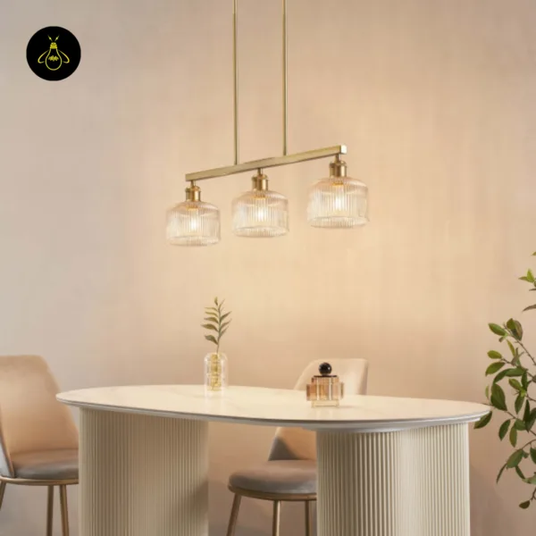 Side view of the ribbed glass chandelier over a white dining table and plant