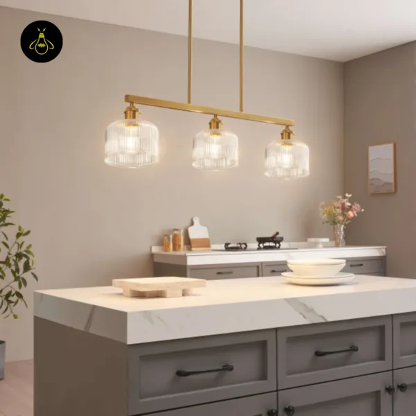 Ribbed glass chandelier over a white marble kitchen island with grey cabinets
