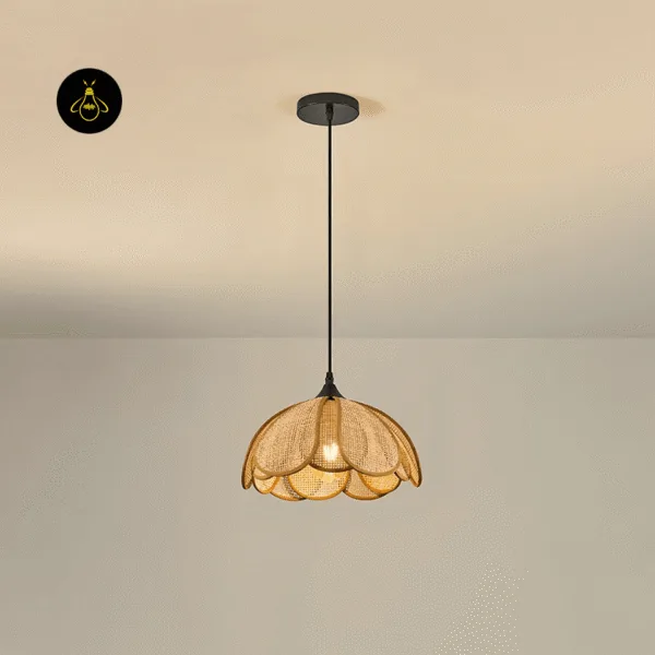 Flower pendant light lit warm, hanging on a black cord from a round black ceiling canopy