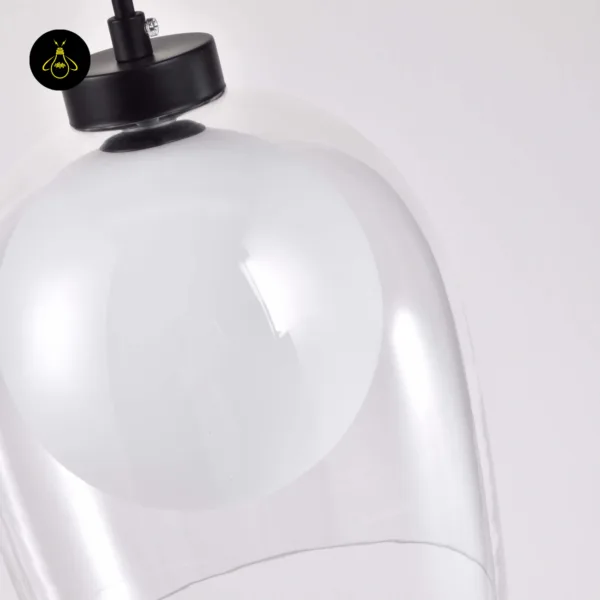 Close-up of the matte black 304 stainless steel cap where the cord meets the clear bell of the glass hanging lamp