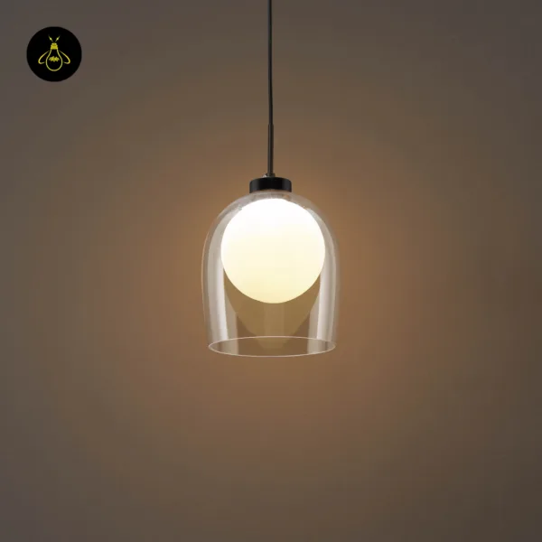 Calypso glass hanging lamp glowing in a dim room, opal globe seen through the clear borosilicate glass bell
