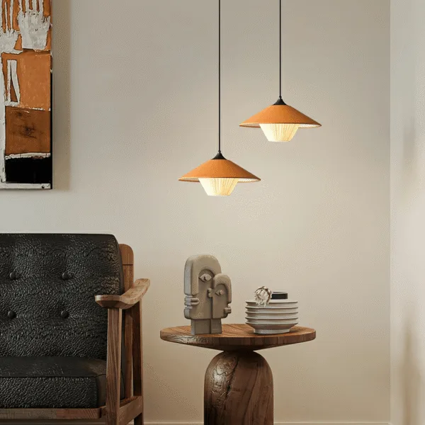 Two orange conical pendant lights at staggered heights in a living room corner, the same kitchen island pendant light