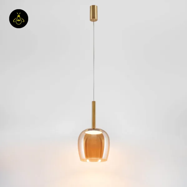 Full bell pendant light lit, with brass-finish canopy, fine cable and amber borosilicate glass bell