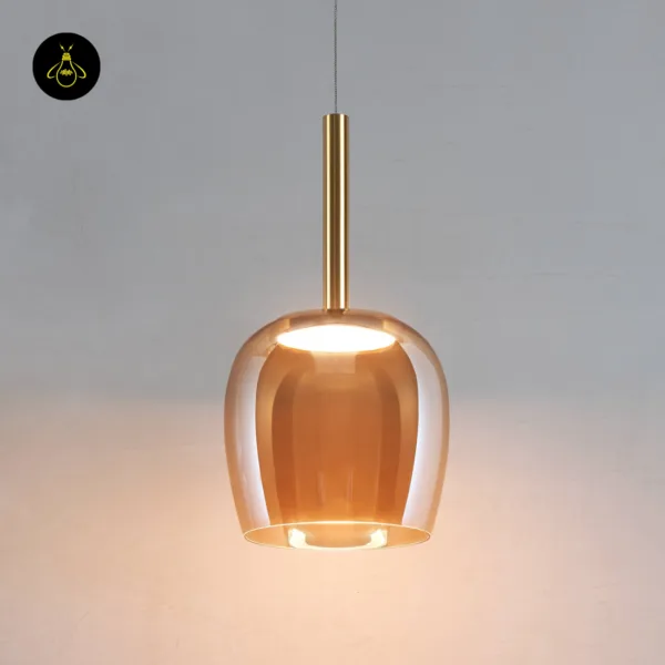 Bell pendant light lit, warm LED glowing inside the amber borosilicate glass bell, front view