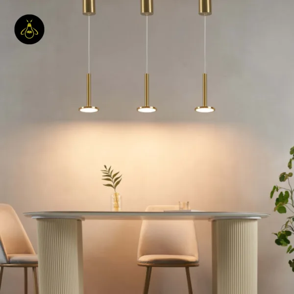 Three bell pendant light fittings without their glass shades, LED discs lit over a dining table