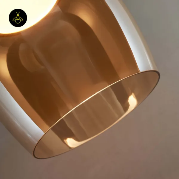 Close-up of the bell pendant light's two-layer amber borosilicate glass and its rim
