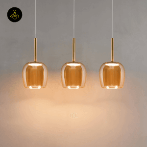 Set of three amber glass bell pendants clustered
