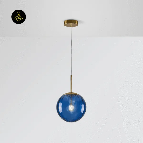 Blue globe hanging light switched on, ribbed blue borosilicate glass on a brushed gold stem