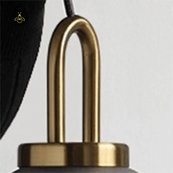 Close-up of the brass-finish stainless steel loop and cap on the glass pendant light