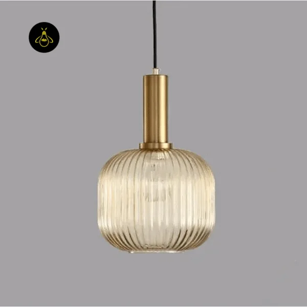 Gold-lustre fluted glass pendant light on a grey background, showing the ribbed glass and brass-finish holder