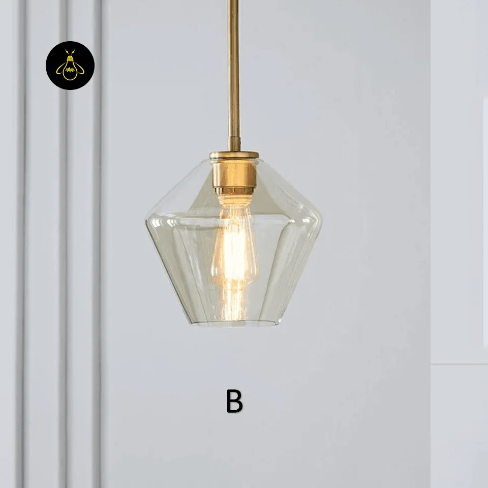 JagMag faceted amber glass pendant light with its E27 holder and bulb seen through the glass, holder in 304 stainless steel
