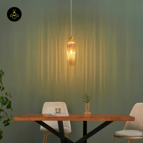 Fluted pendant light glowing over a wooden dining table, throwing vertical amber light bands on a green wall