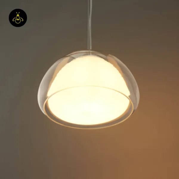 Lomelia double glass pendant light seen from below, opal borosilicate inner shade glowing within the clear outer rim