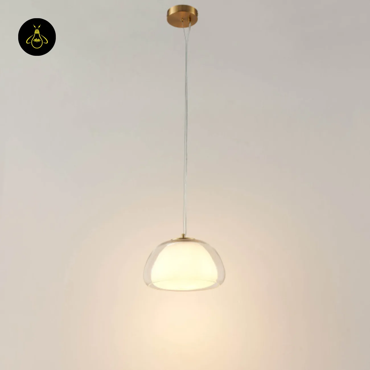Double Glass Pendant Light – Lomelia 25 cm Dome, Gold Finish 8 Lomelia double glass pendant light hanging from a round gold-finish ceiling canopy on a transparent cord, lit with a warm glow