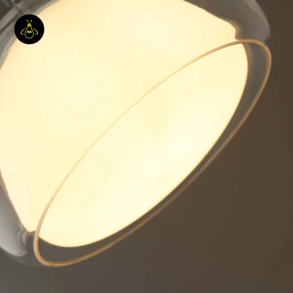 Close-up from below of the Lomelia double glass pendant light, lit opal borosilicate inner shade inside the clear outer rim