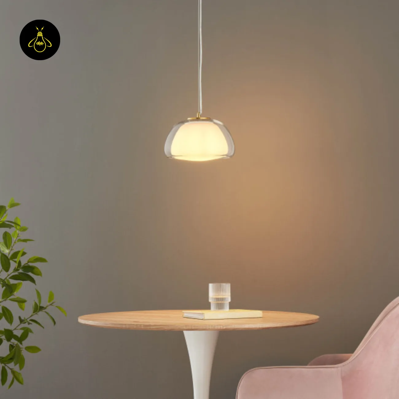 Double Glass Pendant Light – Lomelia 25 cm Dome, Gold Finish 16 Lomelia double glass pendant light lit above a round wood-top table, opal inner shade inside the clear dome