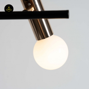 Close-up of white opal glass globe and gold socket on black bar pendant