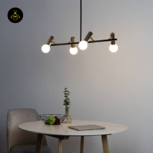 Black and gold globe pendant light glowing over a dining table