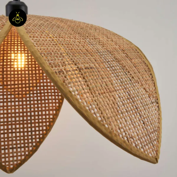 Close-up of one handwoven cane petal and its bound edge on the cane pendant light