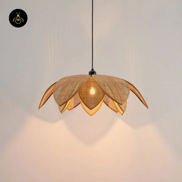 Cane pendant light glowing warm, its lotus petals casting shadows on a pale wall