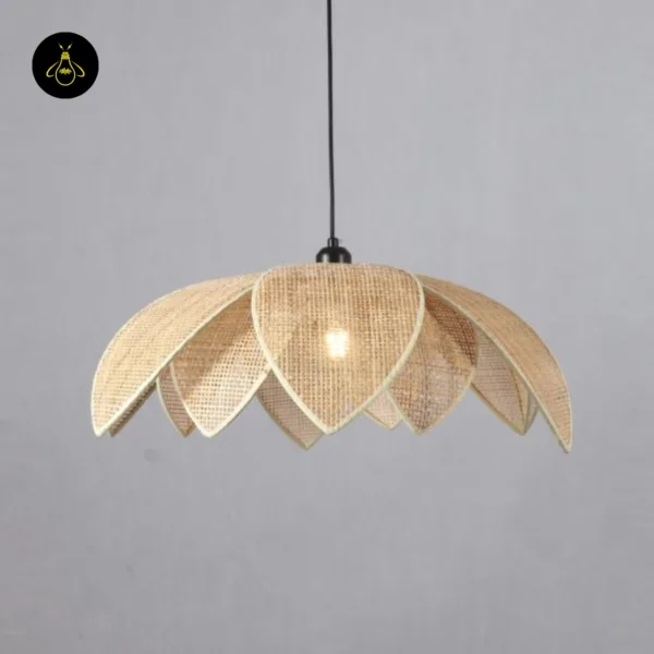 Lit Mariella with two tiers of cane petals and a matte black crown against a grey wall; a cane pendant light
