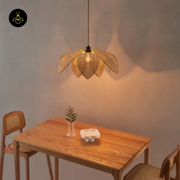 Cane pendant light glowing over a wooden dining table with cane-back chairs