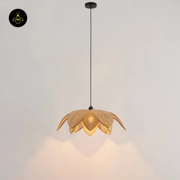 Lit cane pendant light throwing a lotus-shaped glow down a plaster wall