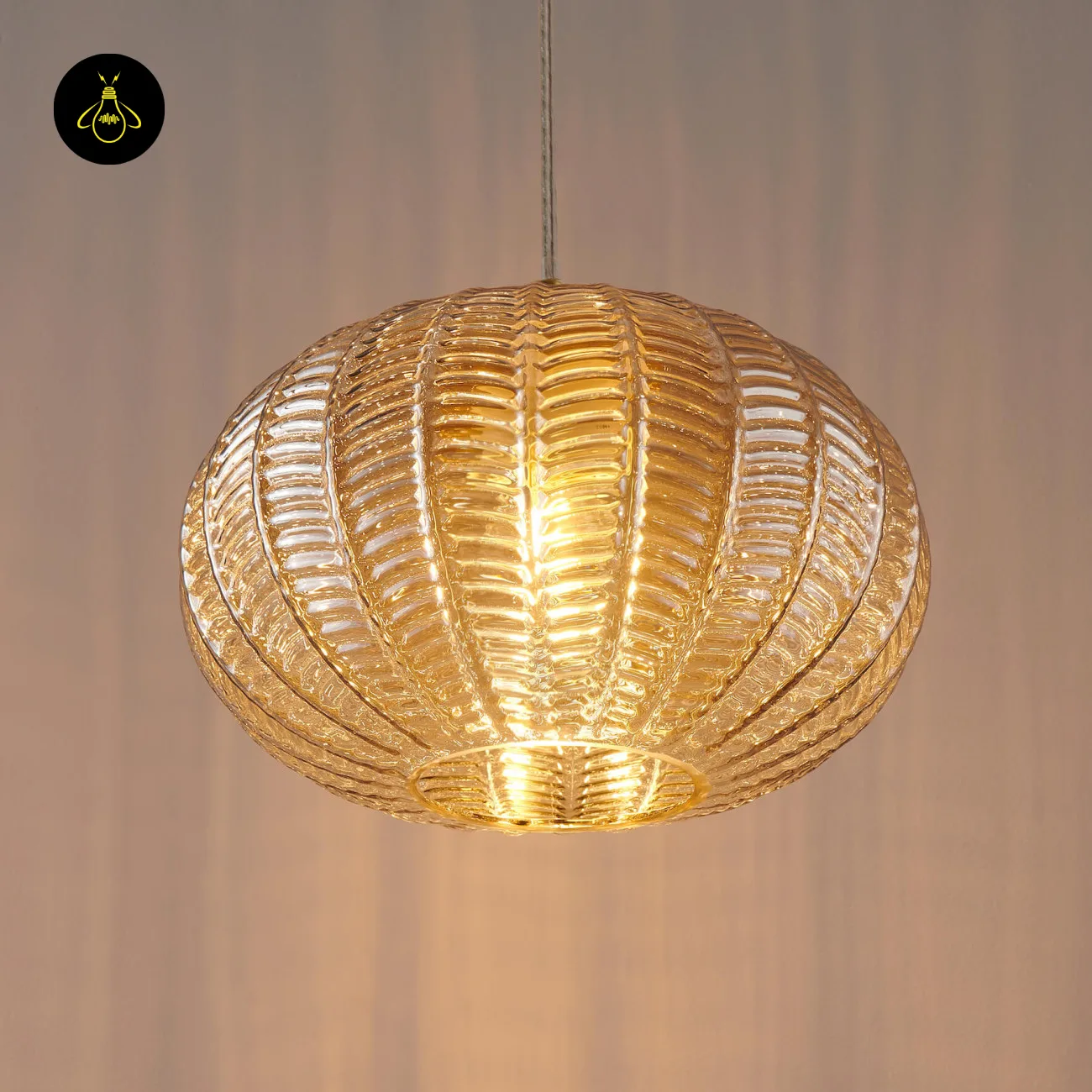Textured Amber Glass Pendant Light – 26 cm Globe, Brass Finish, E27 7 Close front view of a lit textured glass pendant light showing the ribs and open base ring