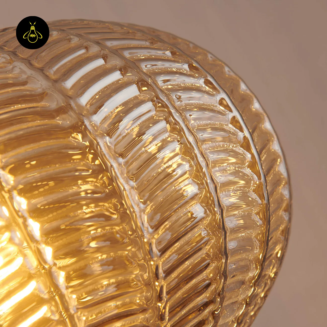 Textured Amber Glass Pendant Light – 26 cm Globe, Brass Finish, E27 9 Close-up of the leaf-pattern relief on an amber textured glass pendant light